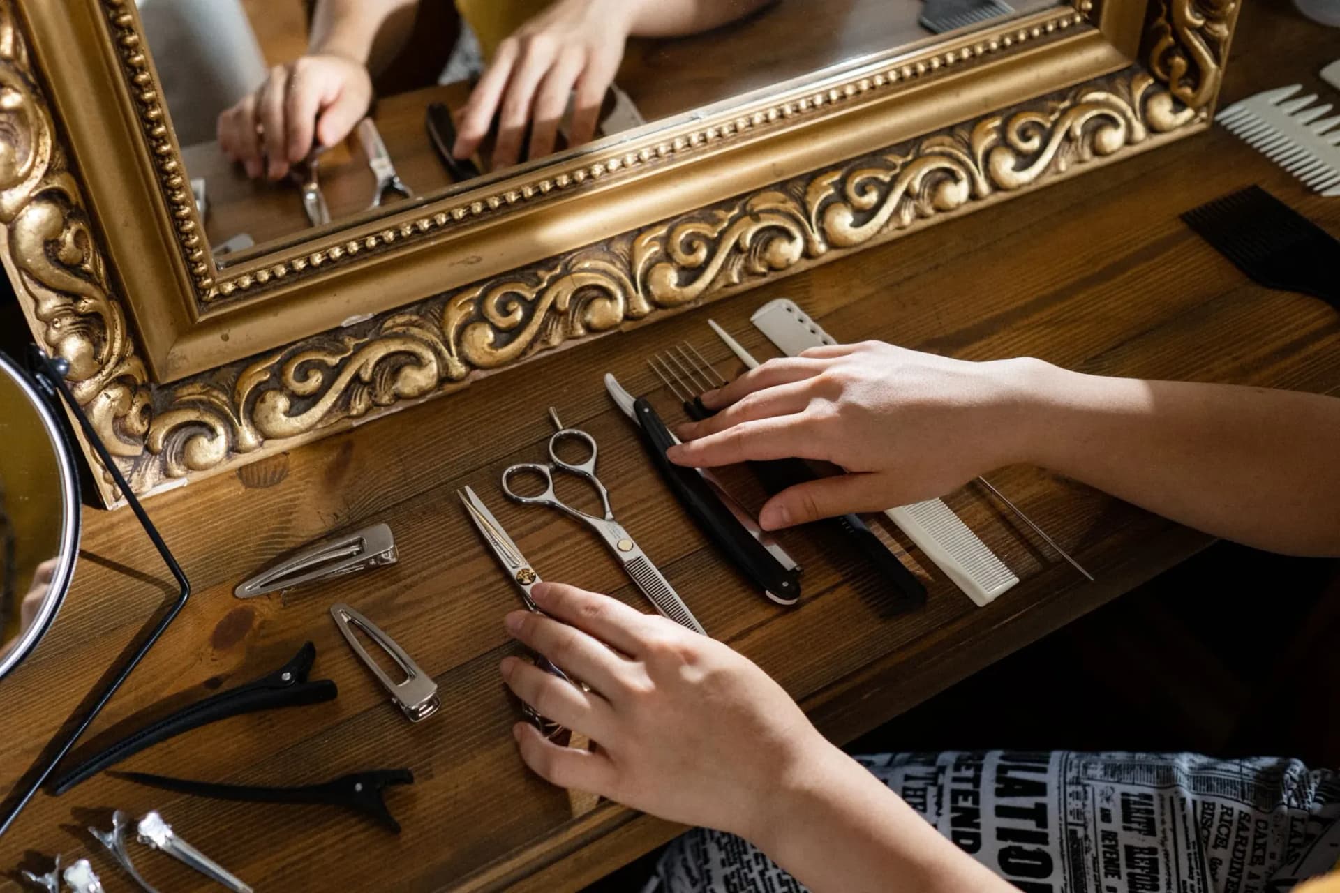Hairdressing tools and hands at a styling station